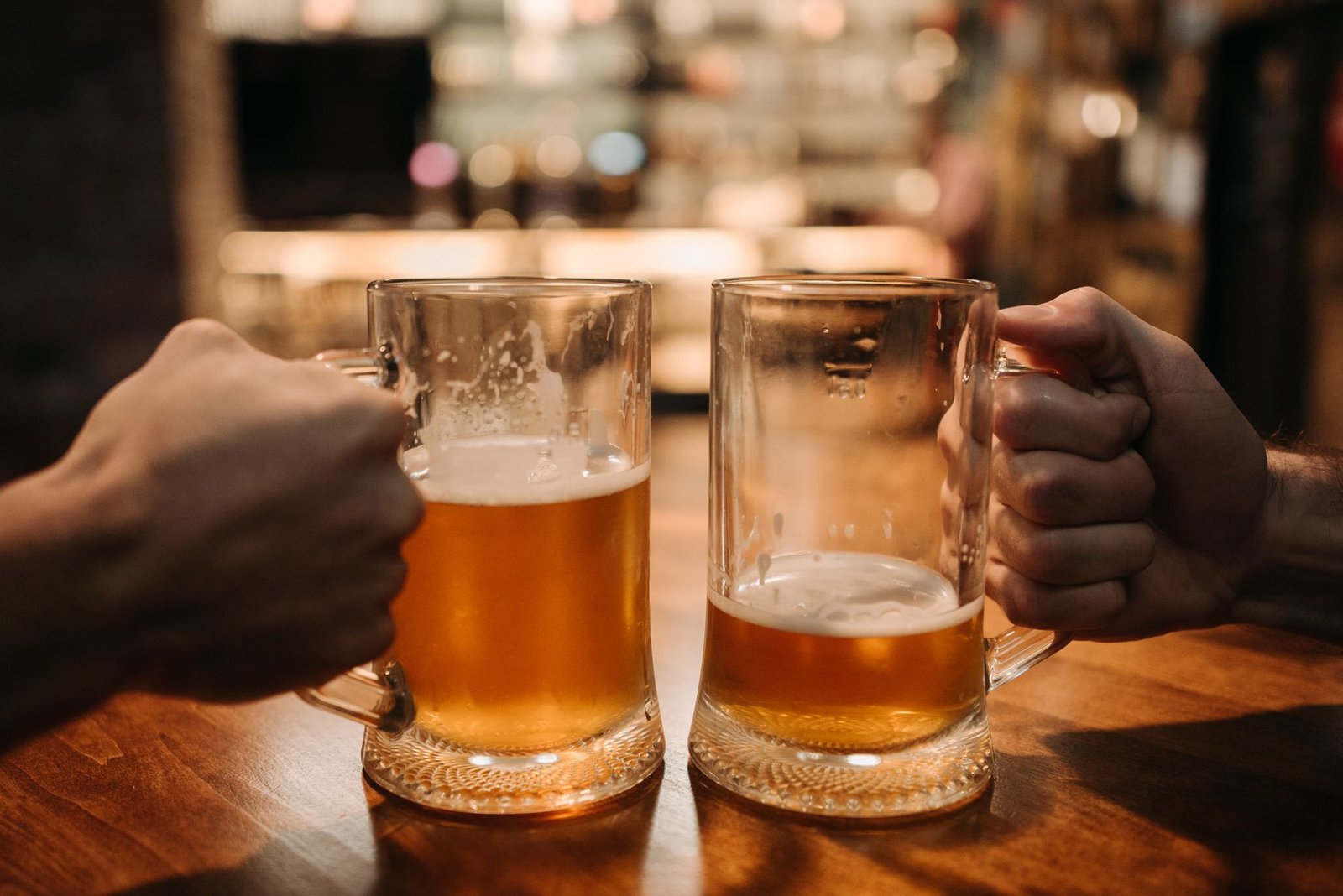 Duas canecas de chopp em uma mesa de bar